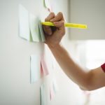 business-executive-writing-sticky-notes